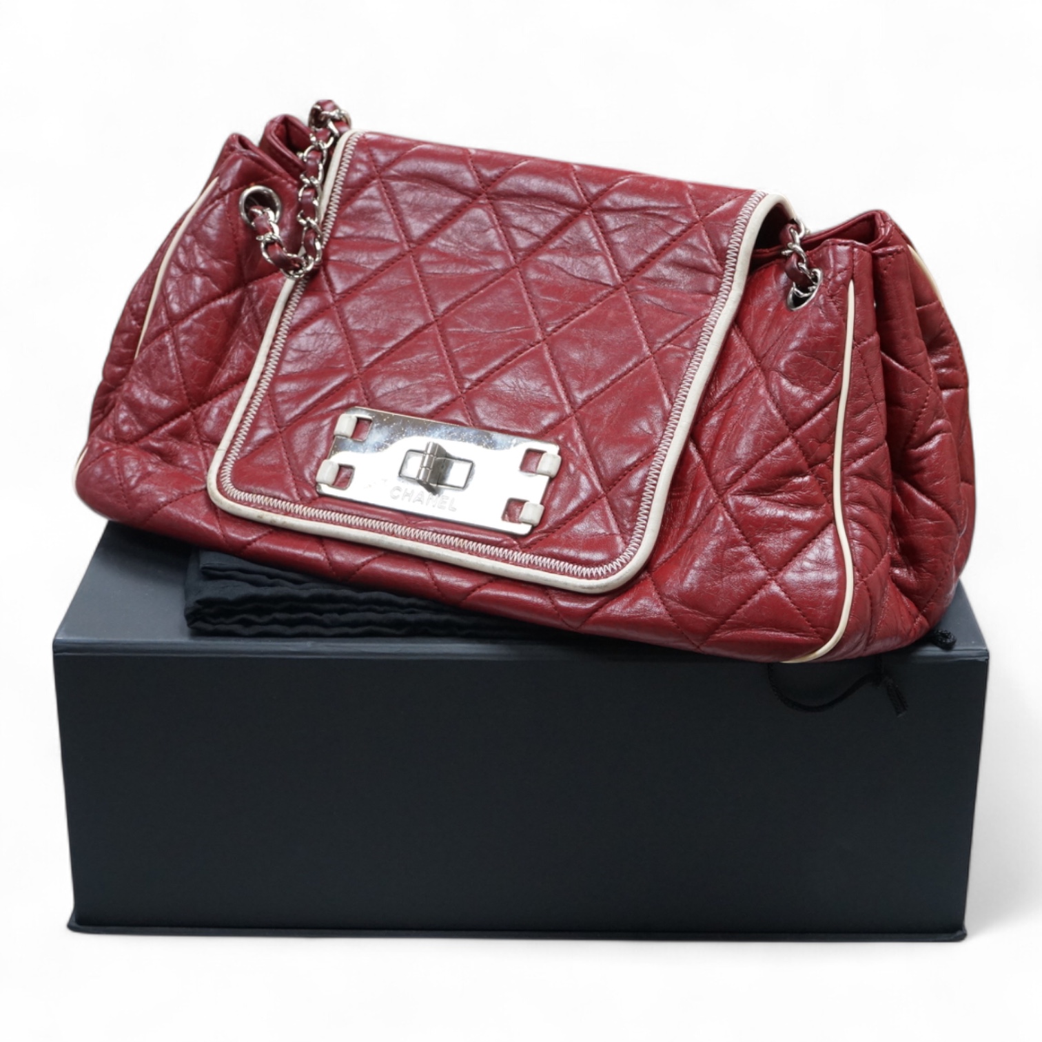 A Chanel East West dark red quilted leather flap shoulder bag with silver hardware, date code 12115484, with original receipt, dust cover and box, 35cm wide, Provenance: purchased by the vendor in Selfridges